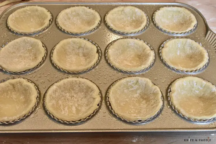 Raw puff pastry in a tartlet pan