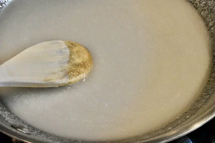 Sugar and water in a fry pan