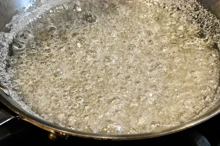 Cooking sugar and water to a low boil over medium heat