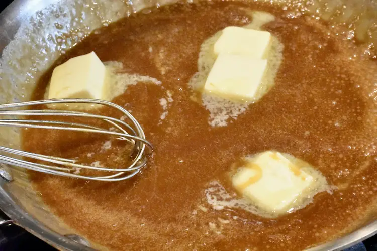 Caramelized sugar, heavy whipping cream, butter and salt in a fry pan