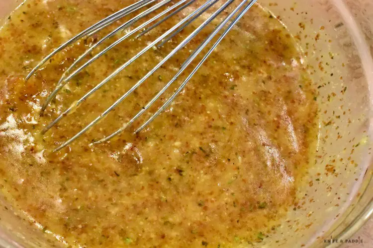 apricot preserves, mustard, thyme, oil & garlic whisked in a bowl