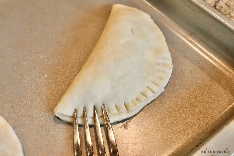 Folded 4 inch pie crust crimped with a fork