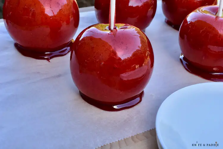 Dipped candy apples on parchment paper