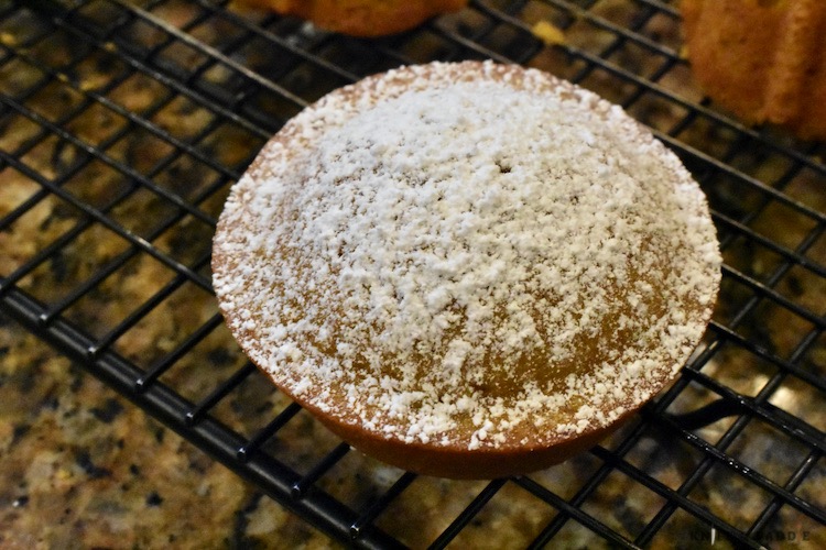 Little pumpkin cake with powdered sugar on a wire rack