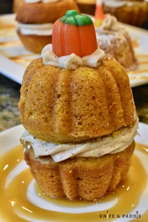 Stuffed pumpkin cake with caramel drizzle on a plate