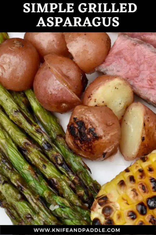 Grilled asparagus, grilled potatoes, grilled corn and steak on a plate