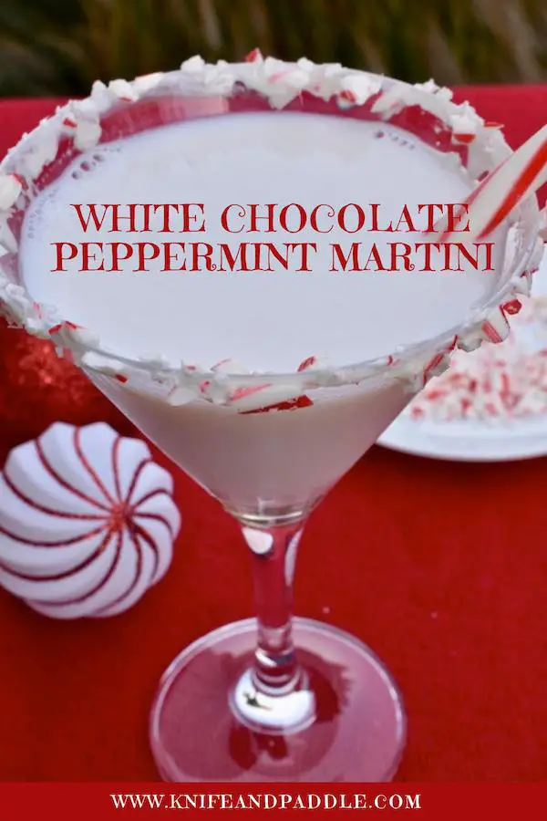 White Chocolate Peppermint Martini in a martini glass coated with marshmallow topping and crushed candy canes