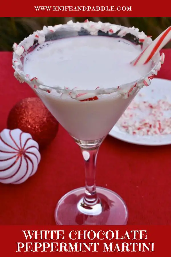 White Chocolate Peppermint Martini in a martini glass coated with marshmallow topping and crushed candy canes