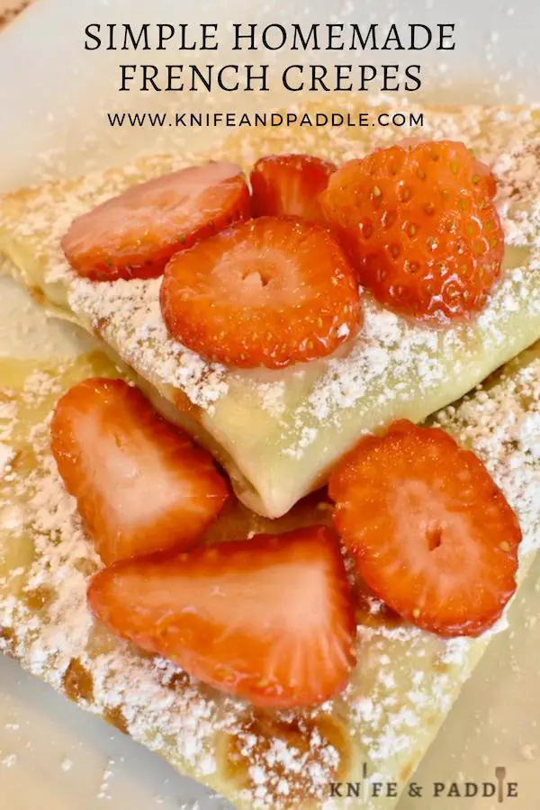 Simple Homemade French Crepes with Nutella filling and topped with strawberries and powdered sugar