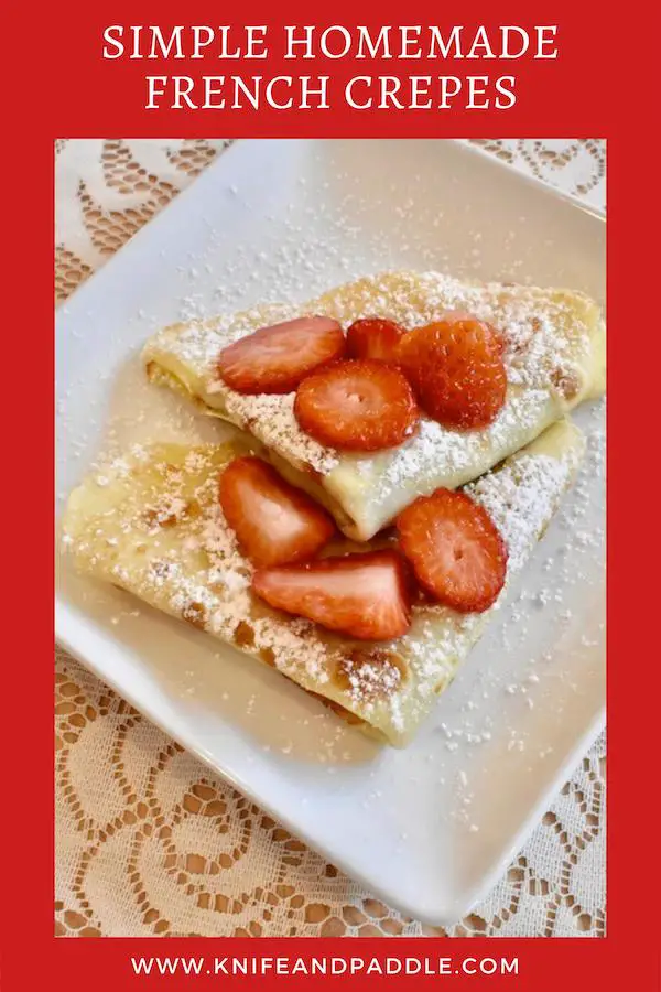 Simple Homemade French Crepes with Nutella filling and topped with strawberries and powdered sugar