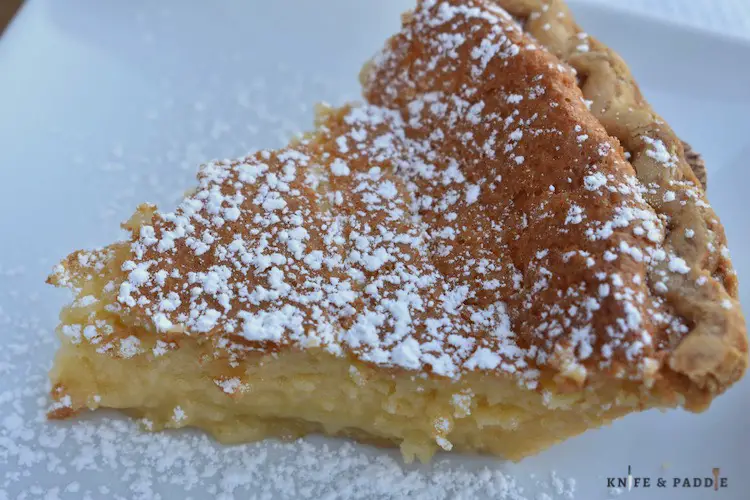 Piece of Chess Pie with powdered sugar on a plate