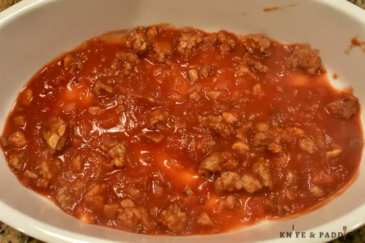 Mushrooms, onions and tomato sauce on the bottom of a large casserole dish