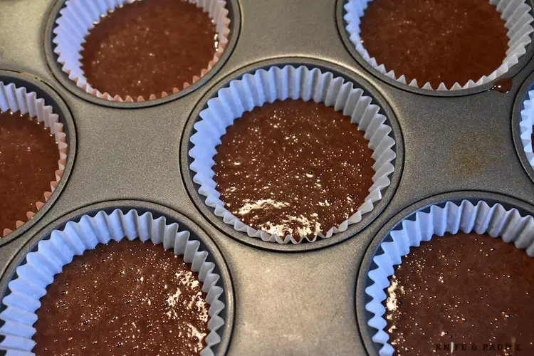 Chocolate batter in cupcake liners halfway full