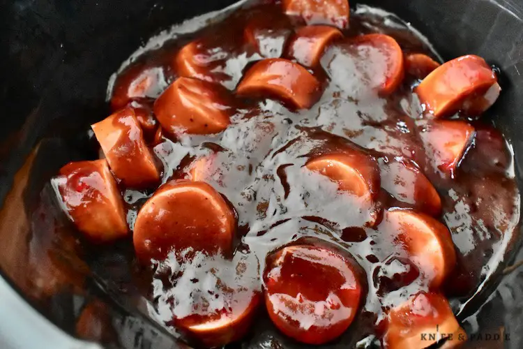 cut up kielbasa, grape jelly and barbecue sauce in a crockpot