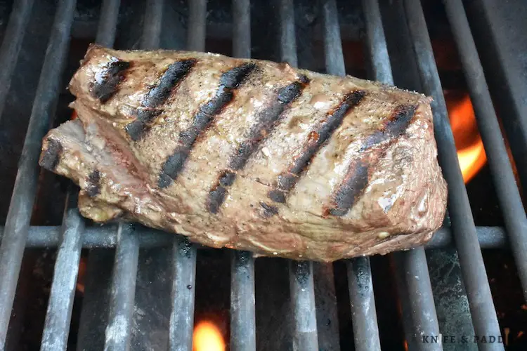 Searing the sides of the meat on a grill 
