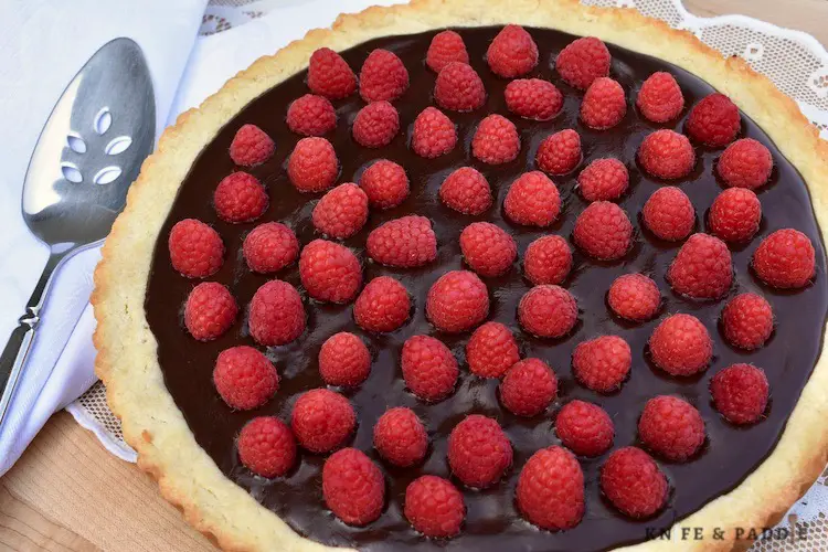 Fresh raspberries on a golden brown crust with chocolate