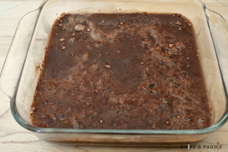 Flour, sugar, baking powder, salt, cocoa powder, vegetable oil, pure vanilla extract and milk mixed together and spread evenly in a 8x8 inch baking dish.  Topped with brown sugar, more cocoa powder. Hot water poured over the batter. 