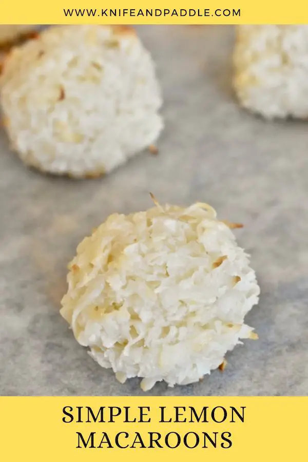 Baked coconut balls on a baking sheet lined with parchment paper