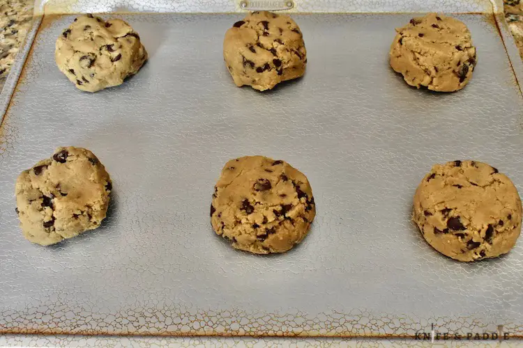 1/2 cup dough balls on a baking sheet