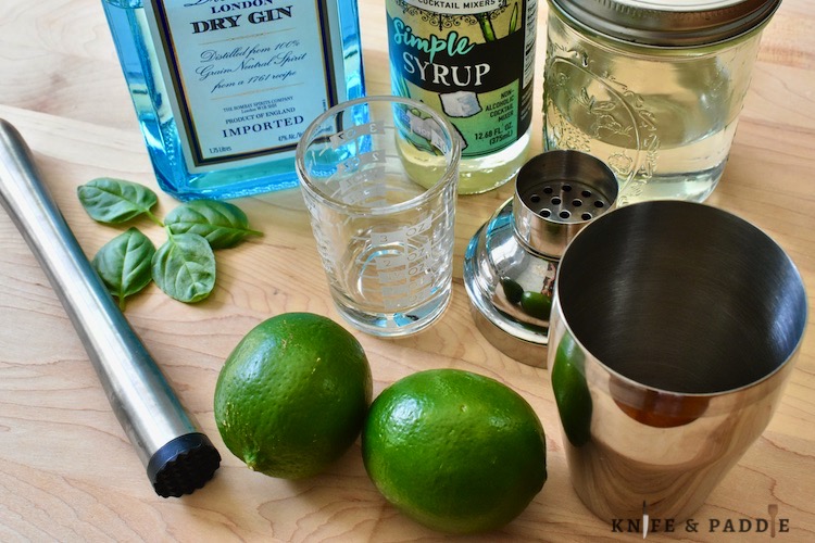 Muddler, fresh basil, gin, simple syrup, cocktail shaker, shot glass, limes