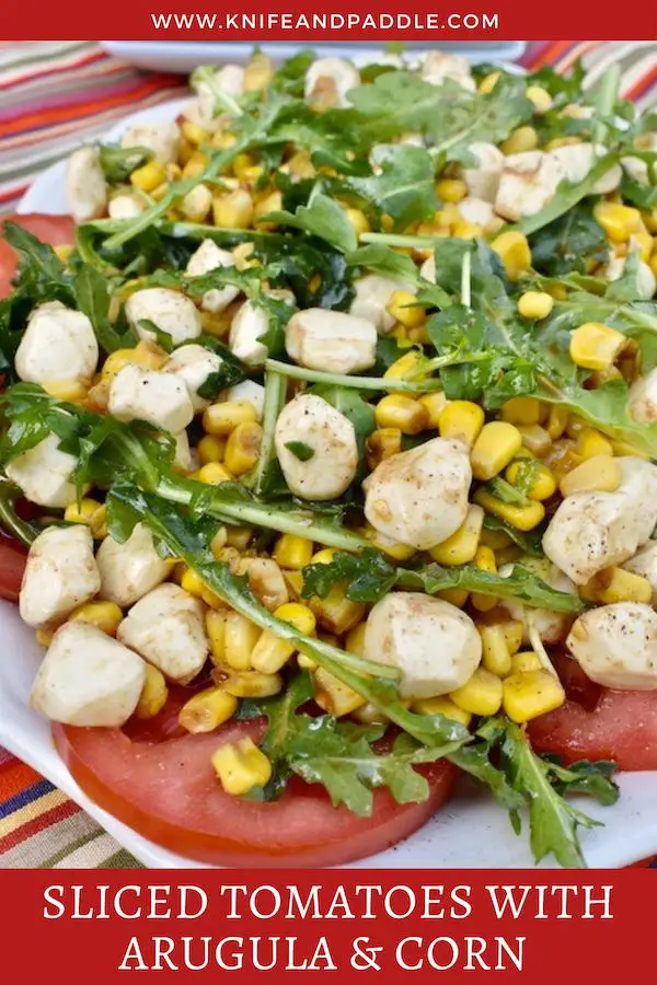 Tomato slices, topped with arugula, corn and mozzarella balls tossed in an olive oil and balsamic dressing