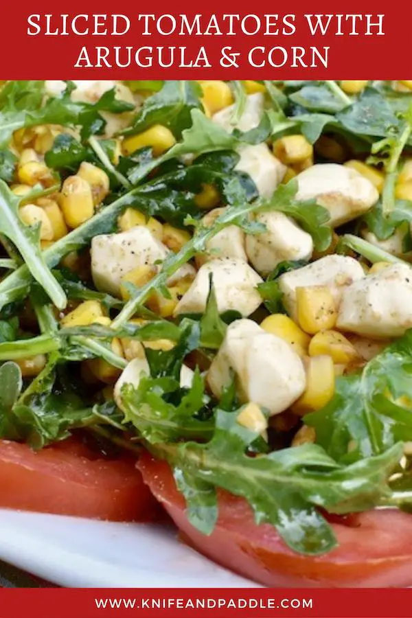 Tomato slices, topped with arugula, corn and mozzarella balls tossed in an olive oil and balsamic dressing