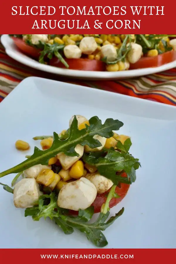 Tomato slice, topped with arugula, corn and mozzarella balls tossed in an olive oil and balsamic dressing