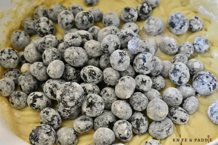 Flour coated blueberries in batter
