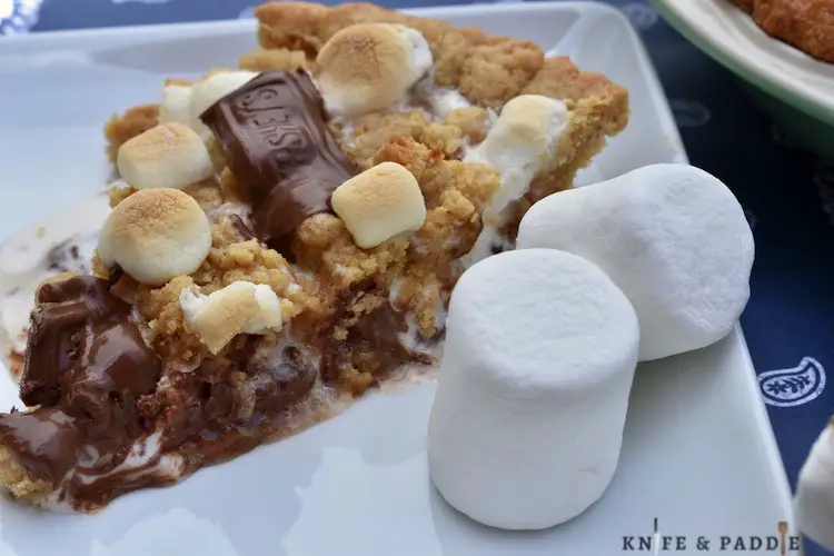 Graham crackers, roasted marshmallows, chocolate bars oozing on a plate