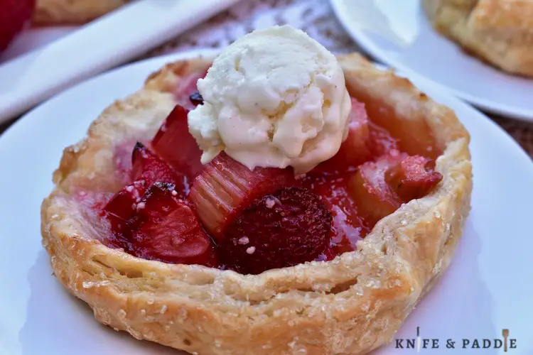 Rustic fruit pie on a plate with vanilla ice cream