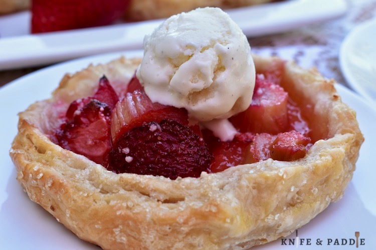 Strawberry Rhubarb Galette with vanilla ice cream on a plate