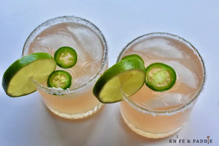 Mexican Drinks with jalapeños and a lime slice for garnish