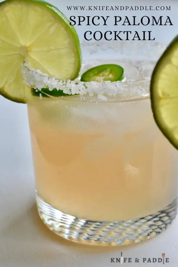 Spicy Paloma Cocktails with jalapeños and lime slice for garnish