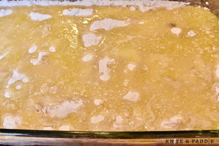 pie filling with extracts, white cake mix and melted butter in a 9x13 inch baking dish
