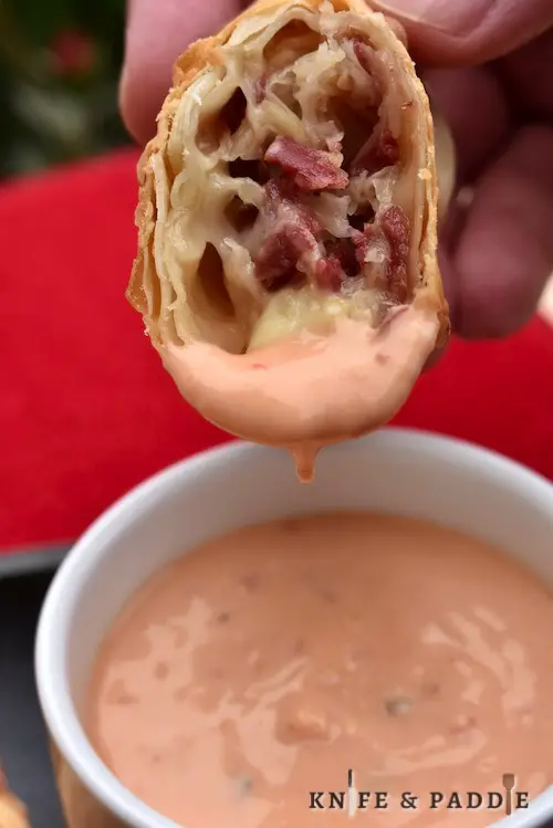 Corned Beef Reuben Egg Roll dipped in Thousand Island Dressing