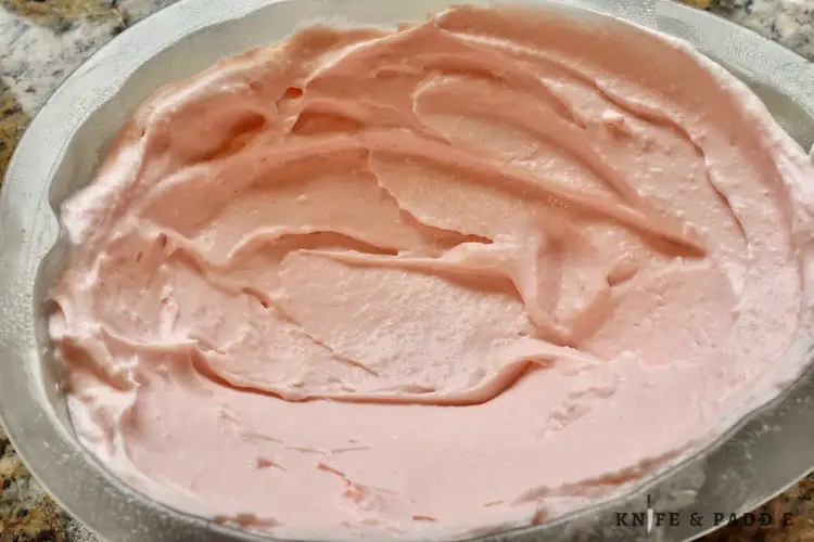 Cream cheese, sugar, gelatin, water, pure vanilla extract, pinch of salt, lemon juice, heavy whipping cream and red food coloring combined and spread in a mold