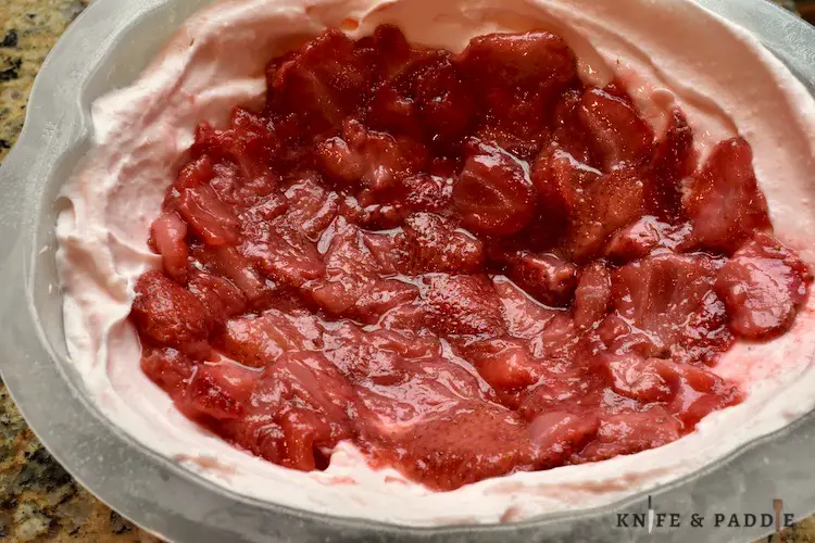 Cream cheese, sugar, gelatin, water, pure vanilla extract, pinch of salt, lemon juice, heavy whipping cream and red food coloring combined and spread in a mold with fresh strawberry filling