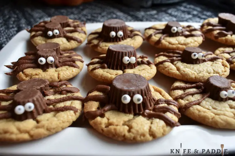 Peanut butter cookies with Reece's Peanut Butter Cups on the top with candy eyeballs and legs 