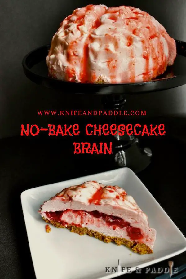 No-Bake Cheesecake Brain covered in strawberry sauce sliced and served on a plate