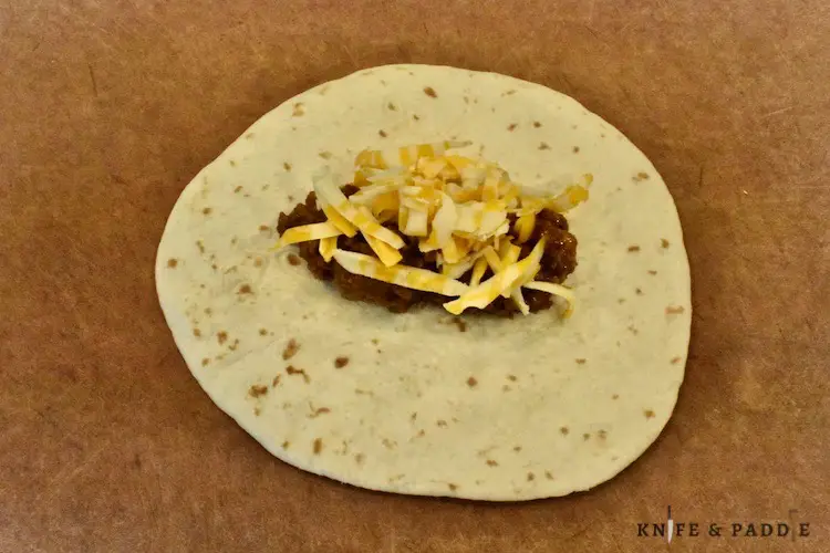 tortilla, ground meat, shredded cheese