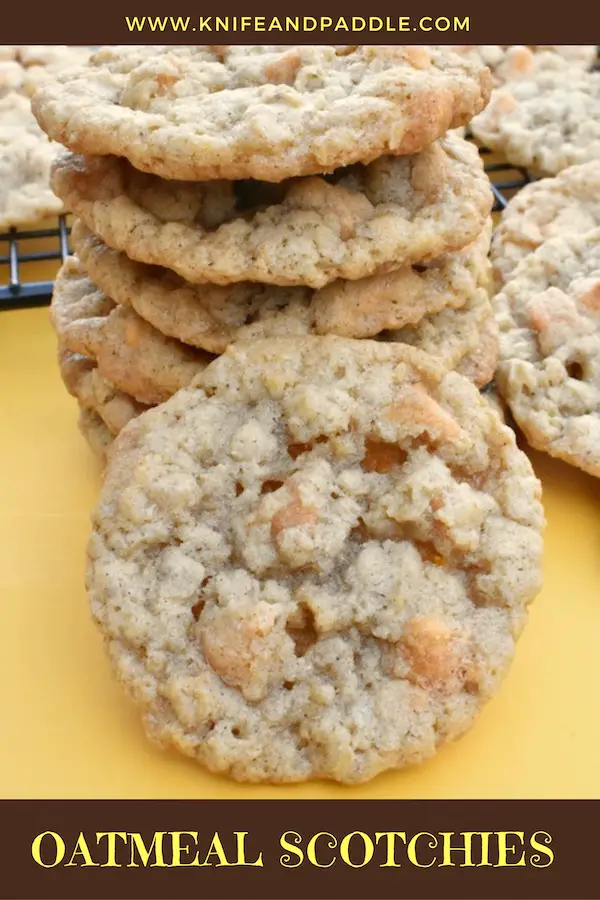Oats and butterscotch chip cookies stacked and on a wire rack