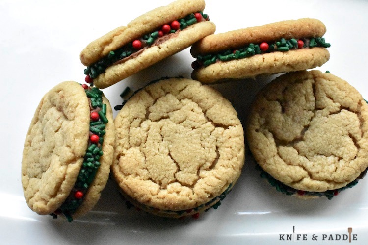 Peanut Butter Sandwich Cookies on a plate with Christmas sprinkles