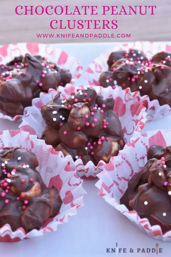 Crockpot candy on a plate with red, white and pink nonpareils in Valentine's Day wrappers