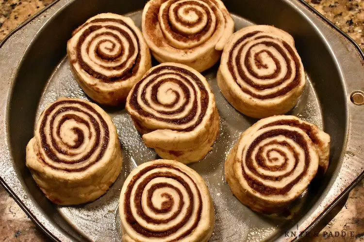 Frozen bread dough thawed, risen and rolled with butter, cinnamon and sugar topping in a prepared baking pan