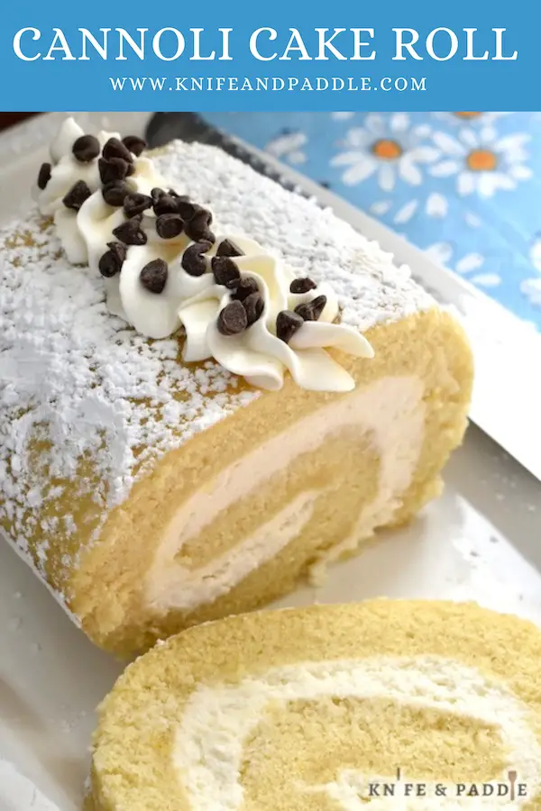 Cannoli Cake Roll with pipped with frosting and topped with mini-chocolate chips