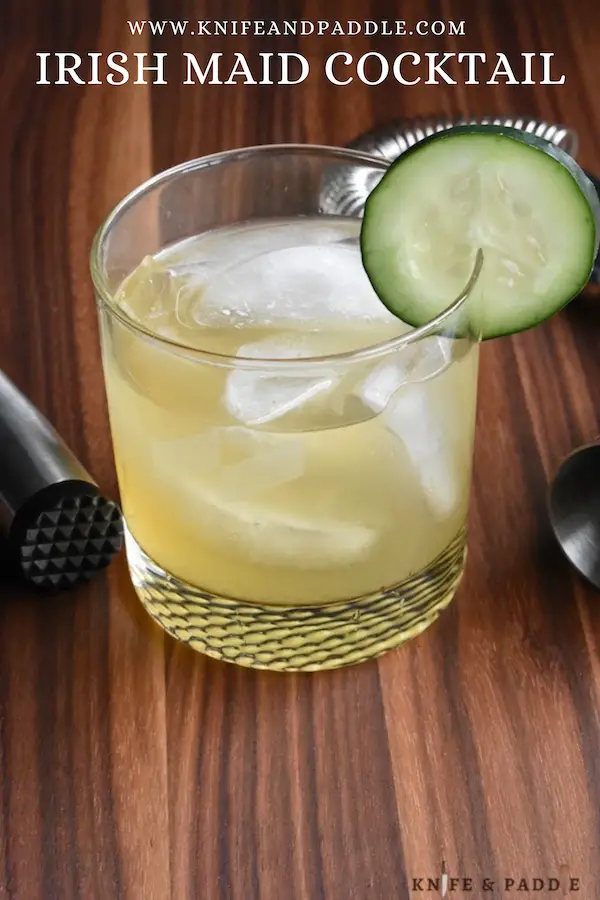 Irish Maid Cocktail in a lowball glass filled with ice and garnished with a cucumber slice