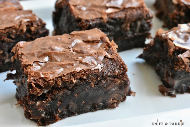Decadent Fudge Brownies cut into squares on a plate