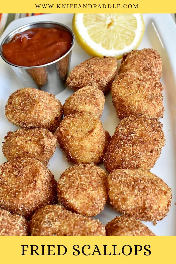 Fried Scallops with a lemon wedge and cocktail sauce