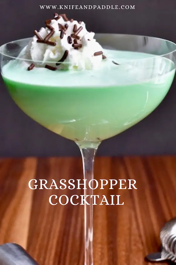 Grasshopper Cocktail in a coupe glass with whipped cream and chocolate sprinkles