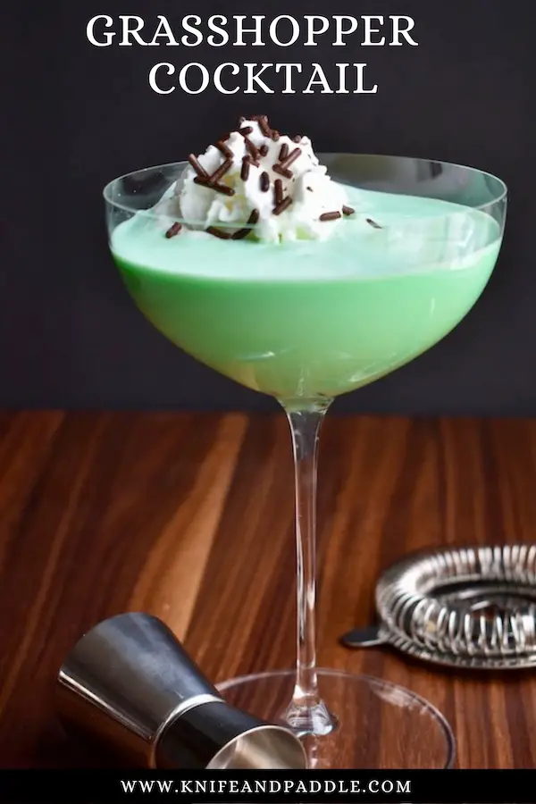 Grasshopper Cocktail in a coupe glass with whipped cream and chocolate sprinkles